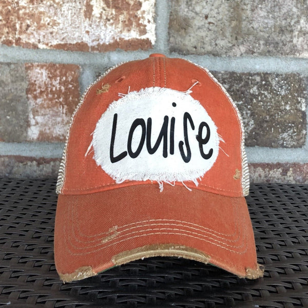 Louise hat by BohoGroove with black Louise lettering on a distressed off-white patch on an orange vintage distressed snapback.