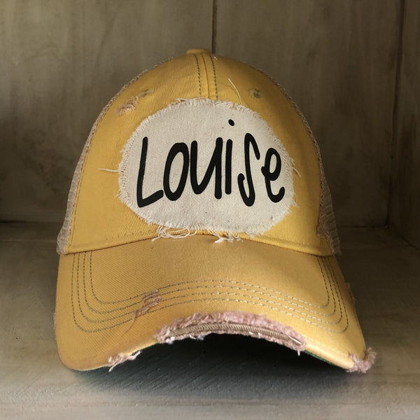 Louise hat by BohoGroove with black Louise lettering on a distressed off-white patch on a yellow vintage distressed snapback.