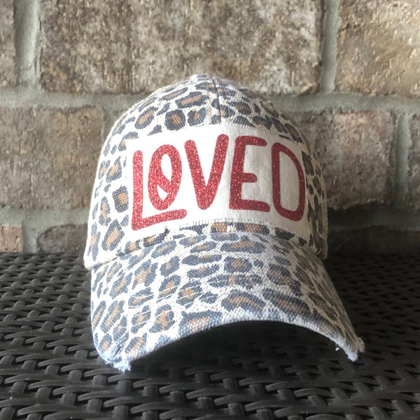 Loved hat by BohoGroove with red glitter Loved lettering on a leopard vintage distressed snapback trucker hat.