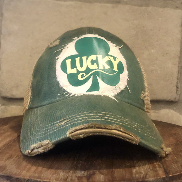 Lucky hat by BohoGroove with green lettering and shamrock graphic on a distressed off-white custom patch on a green vintage distressed snapback.
