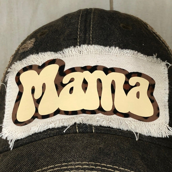 Mama hat by BohoGroove with ivory Mama lettering and leopard outline detail on a distressed off-white patch on a black vintage distressed snapback close up