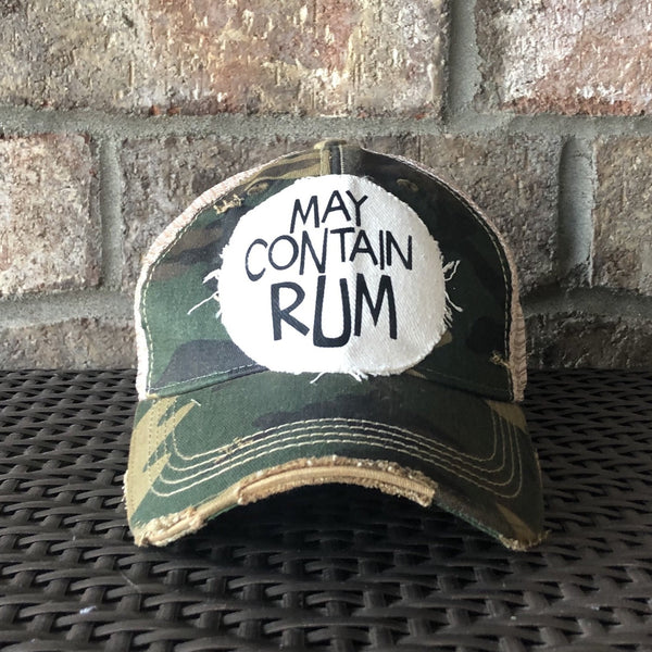 May Contain Rum hat by BohoGroove featuring distressed off-white patch with black writing on a camo vintage distressed snapback