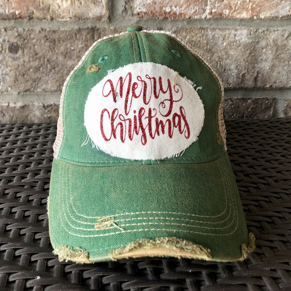Merry Christmas Glitter hat by BohoGroove with red glitter Merry Christmas script lettering on a distressed off-white custom patch on a green vintage distressed snapback.