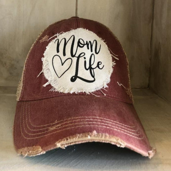Mom Life hat by BohoGroove with black Mom Life lettering and heart graphic on a distressed off-white patch on a brick red vintage distressed snapback.