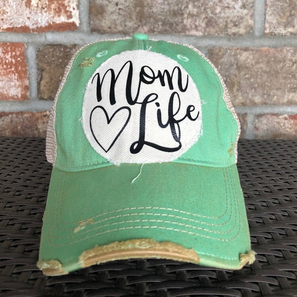 Mom Life hat by BohoGroove with black Mom Life lettering and heart graphic on a distressed off-white patch on a mint vintage distressed snapback.