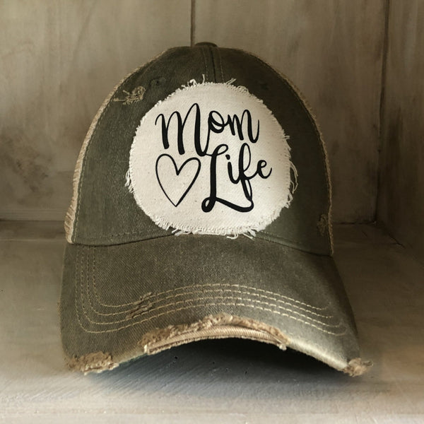 Mom Life hat by BohoGroove with black Mom Life lettering and heart graphic on a distressed off-white patch on an olive vintage distressed snapback.