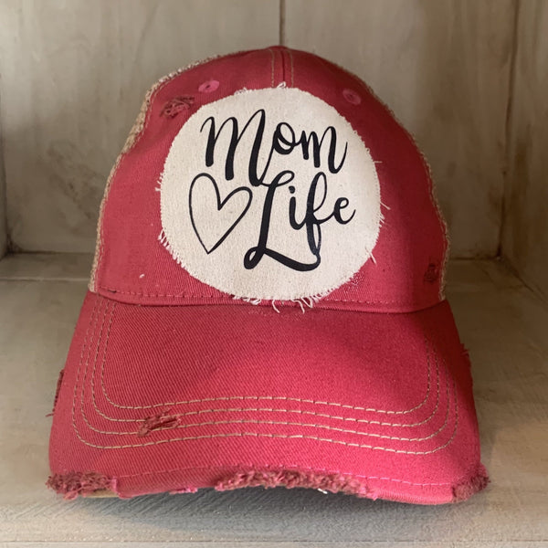 Mom Life hat by BohoGroove with black Mom Life lettering and heart graphic on a distressed off-white patch on a pink vintage distressed snapback.