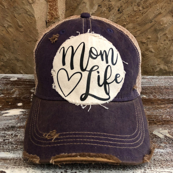 Mom Life hat by BohoGroove with black Mom Life lettering and heart graphic on a distressed off-white patch on a purple vintage distressed snapback.