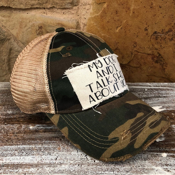 My Dog and I Talk Shit About You hat by BohoGroove with black My Dog and I Talk Shit About You lettering on a distressed off-white patch on a camo vintage distressed snapback left side.