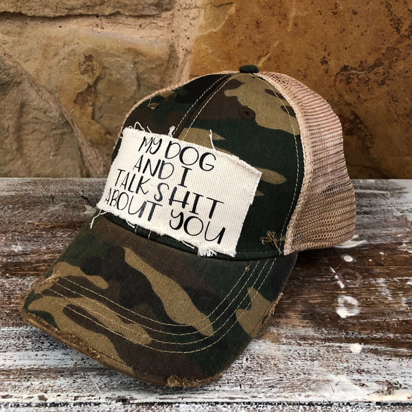 My Dog and I Talk Shit About You hat by BohoGroove with black My Dog and I Talk Shit About You lettering on a distressed off-white patch on a camo vintage distressed snapback right side.