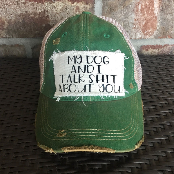 My Dog and I Talk Shit About You hat by BohoGroove with black My Dog and I Talk Shit About You lettering on a distressed off-white patch on a camo vintage distressed snapback.