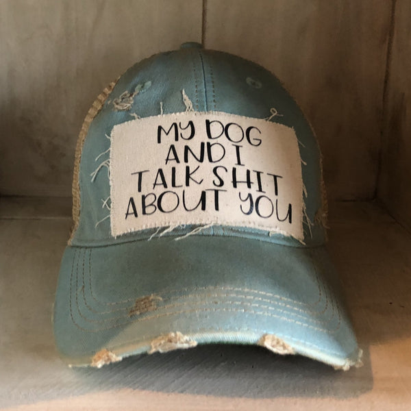 My Dog and I Talk Shit About You hat by BohoGroove with black My Dog and I Talk Shit About You lettering on a distressed off-white patch on a light blue vintage distressed snapback.