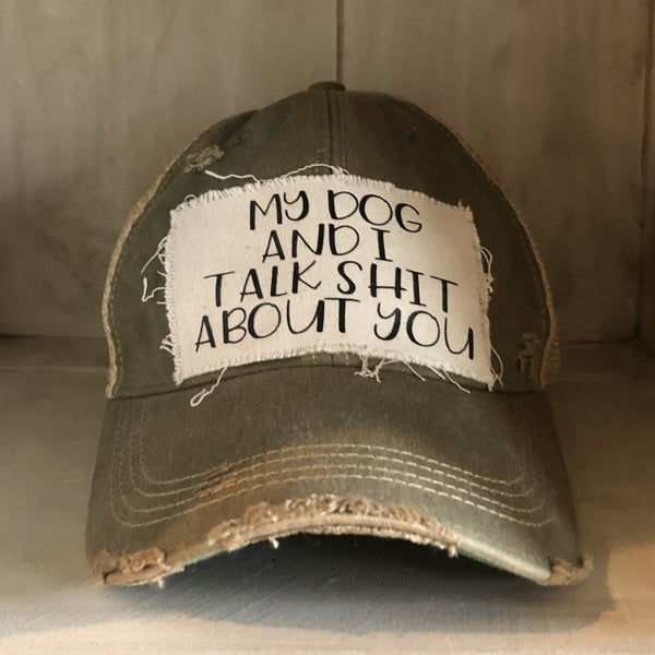 My Dog and I Talk Shit About You hat by BohoGroove with black My Dog and I Talk Shit About You lettering on a distressed off-white patch on an olive vintage distressed snapback.