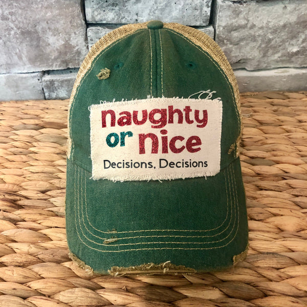 Naughty or Nice hat by BohoGroove with red and green Naughty or Nice lettering and Decisions, Decisions wording on a distressed off-white patch on a green vintage distressed snapback.