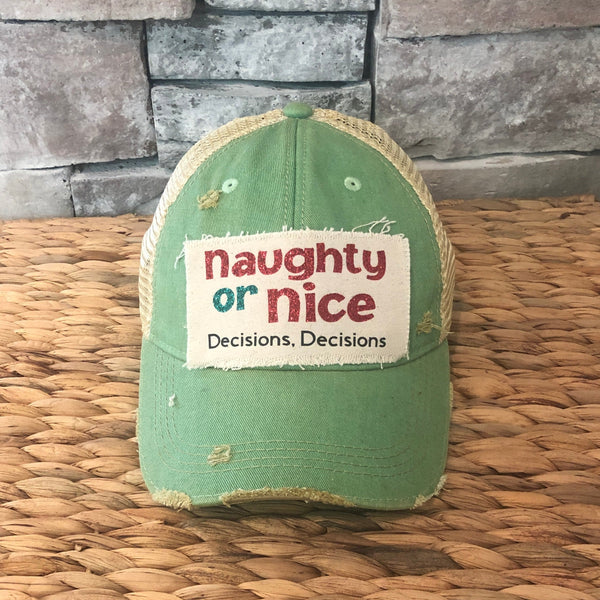 Naughty or Nice hat by BohoGroove with red and green Naughty or Nice lettering and Decisions, Decisions wording on a distressed off-white patch on a mint vintage distressed snapback.