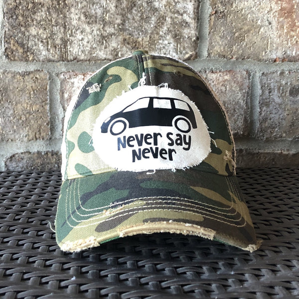 Never Say Never hat by BohoGroove with black minivan graphic and Never Say Never lettering on a distressed off-white patch on a camo vintage distressed snapback trucker hat.