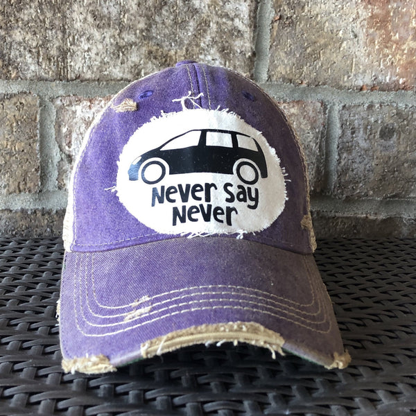 Never Say Never hat by BohoGroove with black minivan graphic and Never Say Never lettering on a distressed off-white patch on a purple vintage distressed snapback trucker hat.
