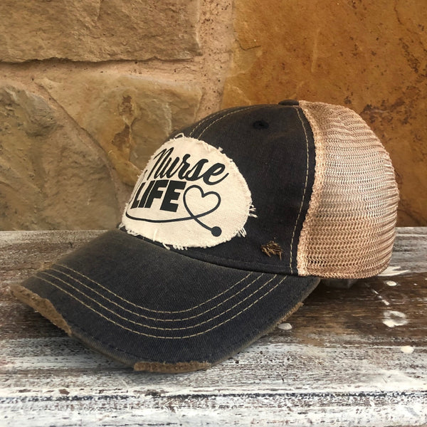 Right side view of the Nurse Life hat by BohoGroove featuring black Nurse Life lettering, stethoscope graphic, and heart detail on a distressed off-white patch on a black vintage distressed snapback.