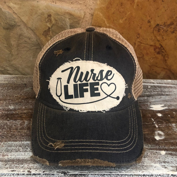 Nurse Life hat by BohoGroove with black Nurse Life lettering, stethoscope graphic, and heart detail on a distressed off-white patch on a black vintage distressed snapback.