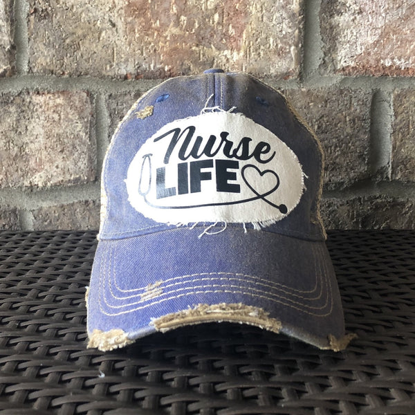 Nurse Life hat by BohoGroove with black Nurse Life lettering, stethoscope graphic, and heart detail on a distressed off-white patch on a royal blue vintage distressed snapback.