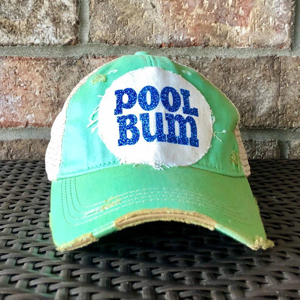 Pool Bum glitter hat by BohoGroove with blue glitter Pool Bum lettering on distressed off-white patch on a mint green vintage distressed snapback.