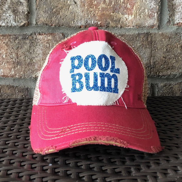 Pool Bum glitter hat by BohoGroove with blue glitter Pool Bum lettering on distressed off-white patch on a pink vintage distressed snapback.