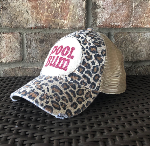 Pool Bum hat by BohoGroove featuring distressed off-white patch with pink glitter Pool Bum lettering on a leopard vintage distressed snapback right side
