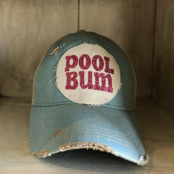 Pool Bum hat by BohoGroove featuring distressed off-white patch with pink glitter Pool Bum lettering on an ocean blue  vintage distressed snapback