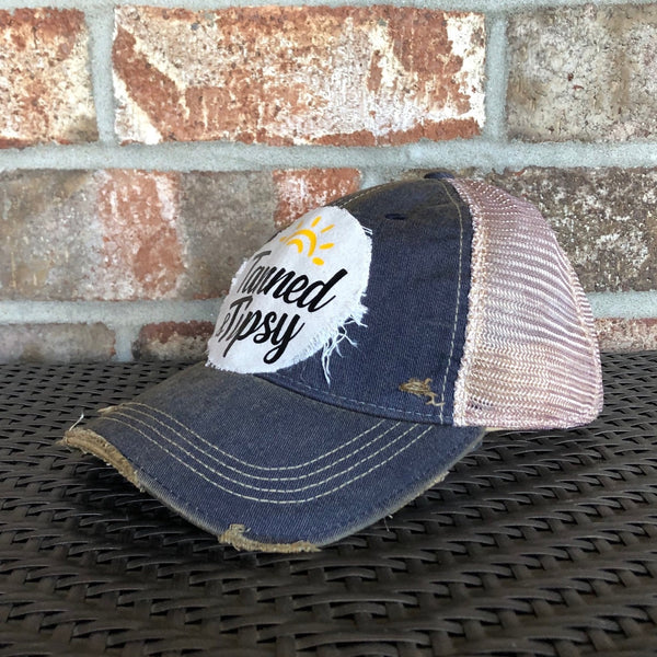 Tanned and Tipsy Hat by BohoGroove on a distressed navy snapback trucker hat with hand-applied patch design and vintage weathered style.
