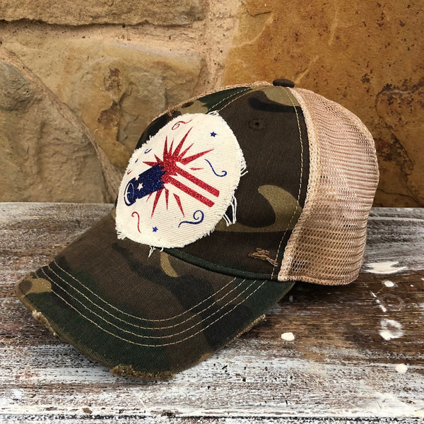 Firework hat by BohoGroove featuring blue glitter firework cannon, red firework burst, and patriotic stars on distressed off-white patch and [color] vintage distressed snapback