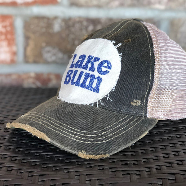 Lake Bum hat by BohoGroove with blue glitter Lake Bum lettering on distressed off-white patch on a black vintage distressed snapback right side.