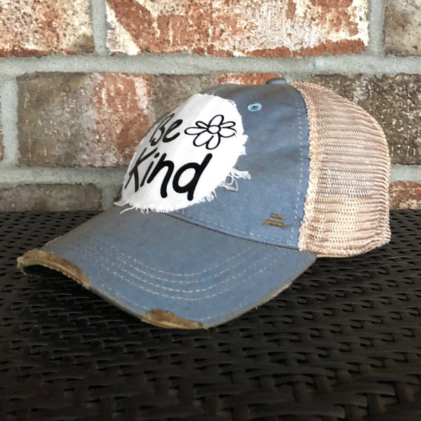 Be Kind hat by BohoGroove with black Be Kind lettering and flower graphic on distressed off-white patch on light blue vintage distressed snapback.