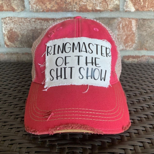 Ringmaster of the Shit Show hat by BohoGroove with black Ringmaster of the Shit Show lettering on a distressed off-white patch on a pink vintage distressed snapback trucker hat.