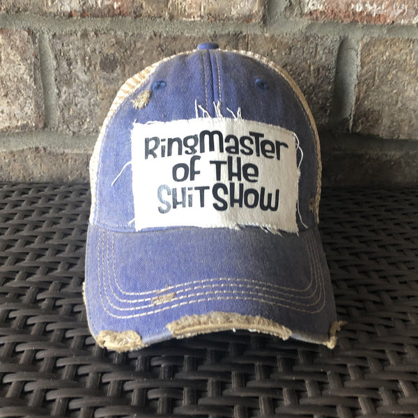 Ringmaster of the Shit Show hat by BohoGroove with black Ringmaster of the Shit Show lettering on a distressed off-white patch on a royal blue vintage distressed snapback trucker hat.