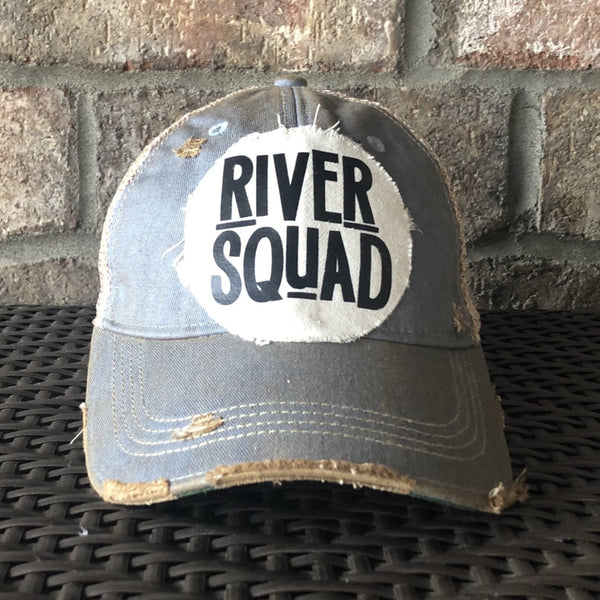 River Squad hat by BohoGroove featuring distressed off-white patch with black River Squad lettering on a light blue vintage distressed snapback