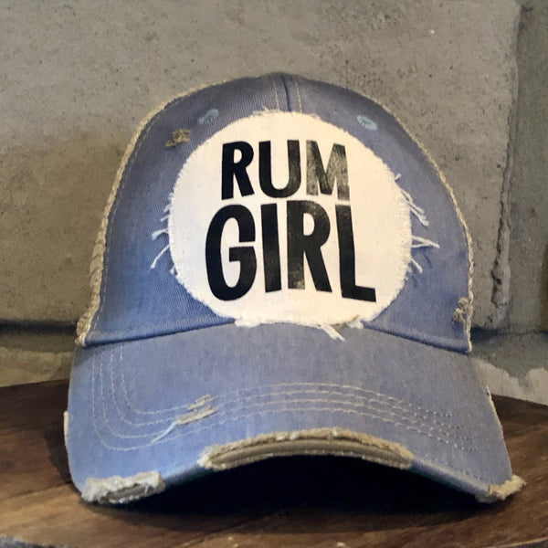 Rum Girl hat by BohoGroove with bold black Rum Girl lettering on a distressed off-white patch on a light blue vintage distressed snapback trucker hat.