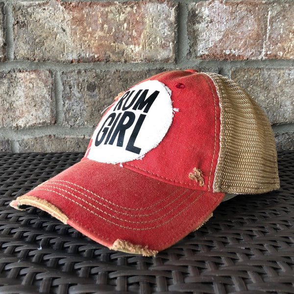 Ride side view of Rum Girl hat by BohoGroove with bold black Rum Girl lettering on a distressed off-white patch on a red vintage distressed snapback trucker hat.