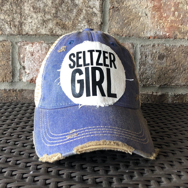 Seltzer Girl hat by BohoGroove with black lettering on a distressed off-white patch on a royal blue vintage distressed snapback trucker hat.
