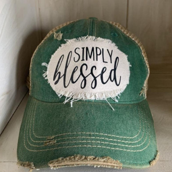 Simply Blessed hat by BohoGroove with black Simply Blessed lettering on a distressed off-white patch on a green vintage distressed snapback.