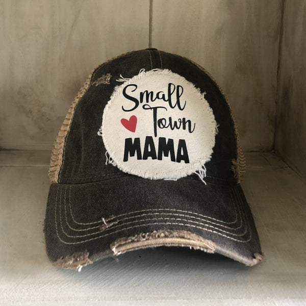 Small Town Mama hat by BohoGroove with black Small Town Mama lettering and red heart graphic on a distressed off-white patch on a black vintage distressed snapback.