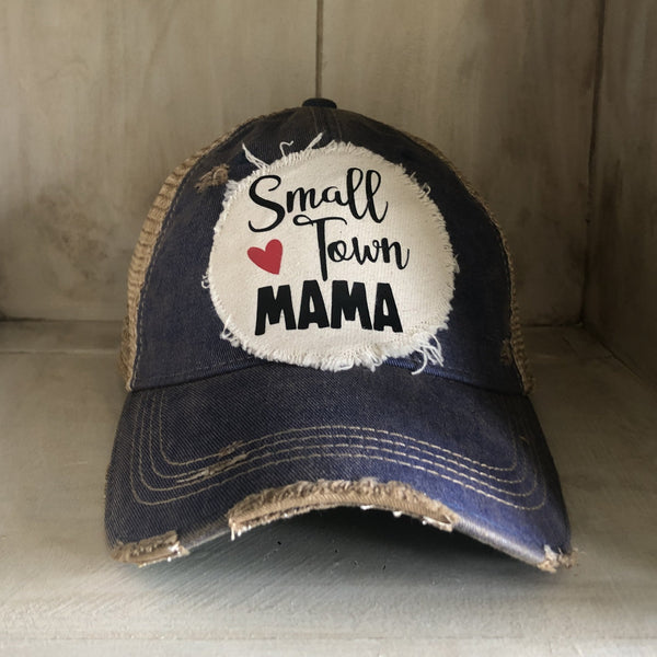 Small Town Mama hat by BohoGroove with black Small Town Mama lettering and red heart graphic on a distressed off-white patch on a navy blue vintage distressed snapback.