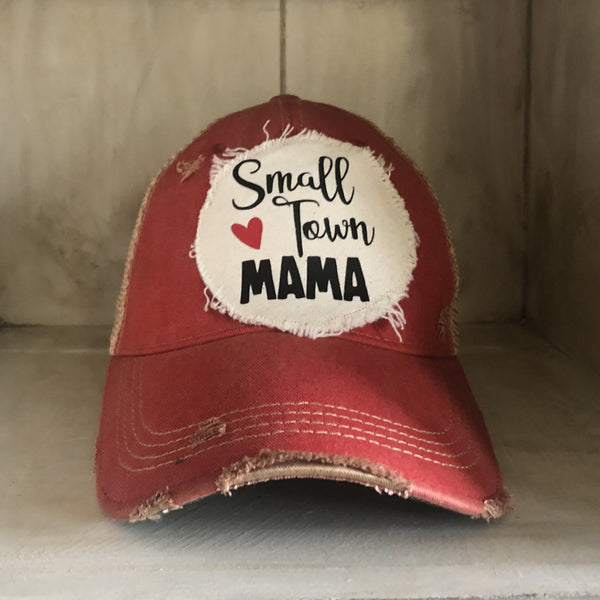 Small Town Mama hat by BohoGroove with black Small Town Mama lettering and red heart graphic on a distressed off-white patch on a red vintage distressed snapback.