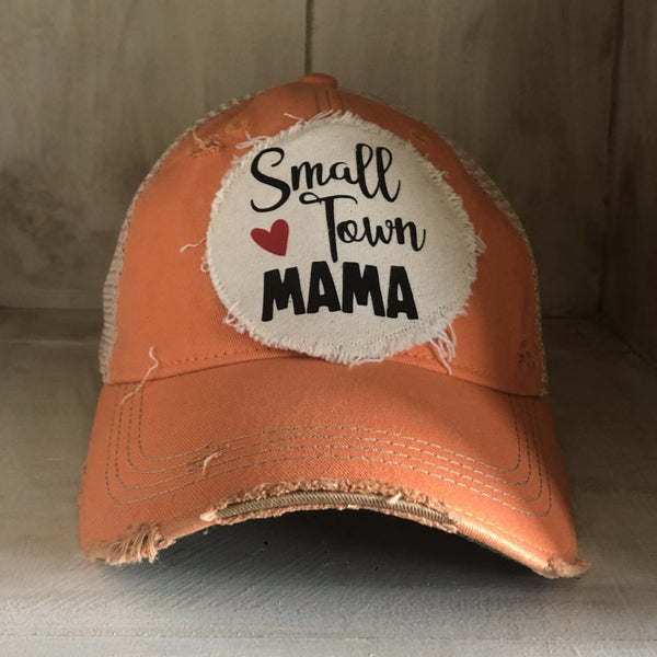Small Town Mama hat by BohoGroove with black Small Town Mama lettering and red heart graphic on a distressed off-white patch on a sherbet vintage distressed snapback.