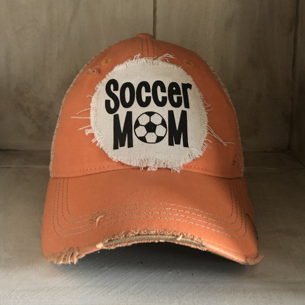 Soccer Mom hat by BohoGroove featuring black Soccer Mom lettering on a sherbet vintage distressed snapback hat