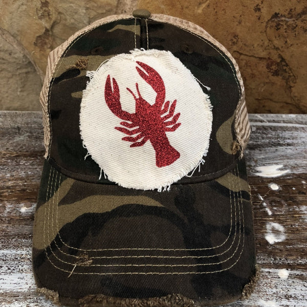 Sparkly Crawfish hat by BohoGroove featuring a red glitter crawfish graphic on a distressed off-white patch on a camo vintage distressed snapback.
