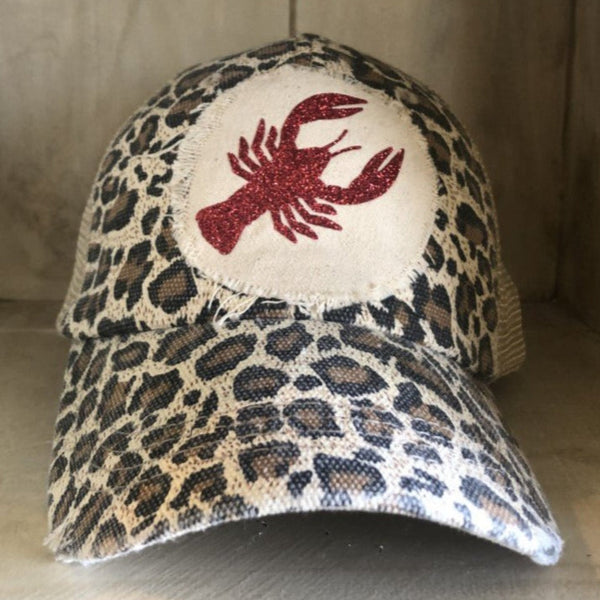 Sparkly Crawfish hat by BohoGroove featuring a red glitter crawfish graphic on a distressed off-white patch on a leopard vintage distressed snapback.