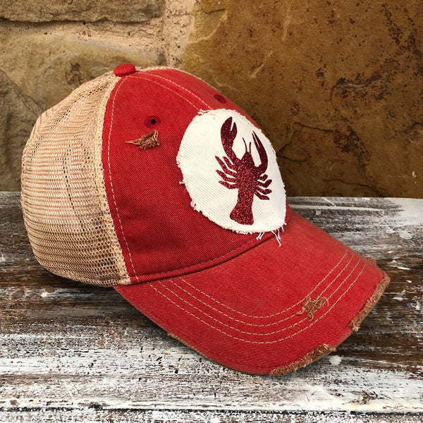 Left side view of the Sparkly Crawfish hat by BohoGroove featuring a red glitter crawfish graphic on a distressed off-white patch on a red vintage distressed snapback.