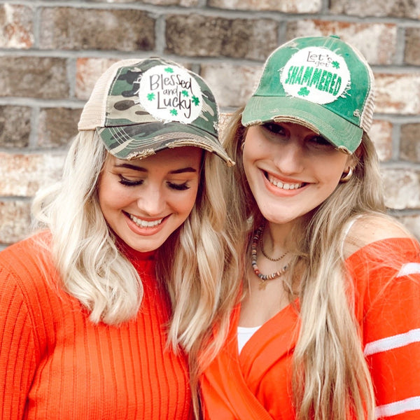 Two women wearing BohoGroove St. Patrick’s Day vintage distressed snapback trucker hats featuring Blessed and Lucky and Let’s Get Shammered patches.