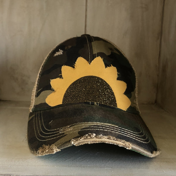 Sunflower hat by BohoGroove with yellow sunflower petals and a black glitter sunflower center on a camo vintage distressed snapback.
