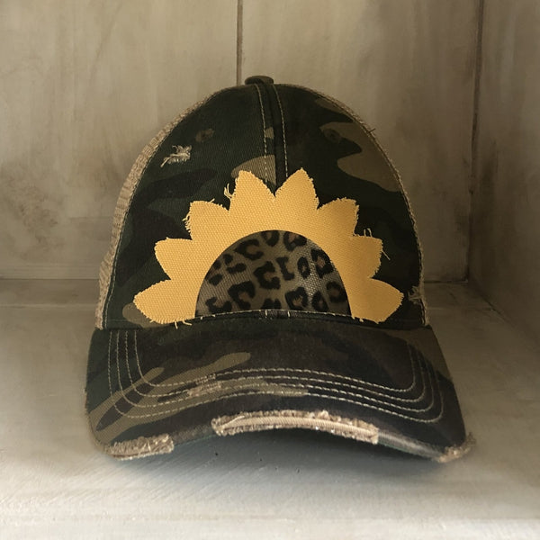 Sunflower hat by BohoGroove featuring yellow sunflower petals and a leopard center on a camo vintage distressed snapback.